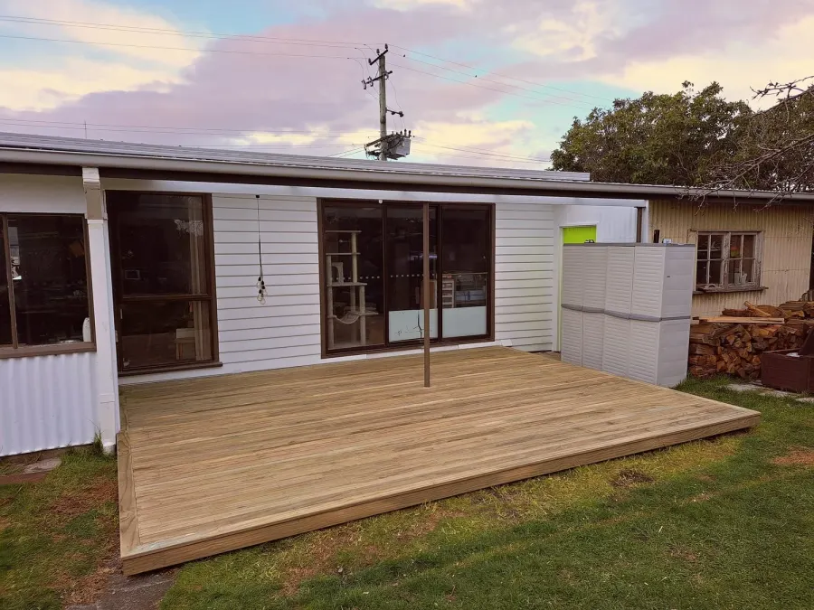 Wide timber deck along the back of a house